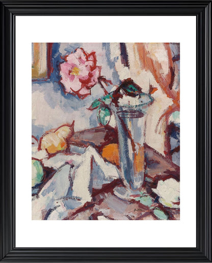 Pink rose in a glass vase with fruit
