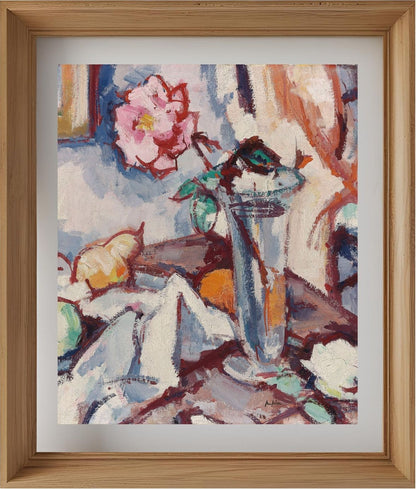 Pink rose in a glass vase with fruit